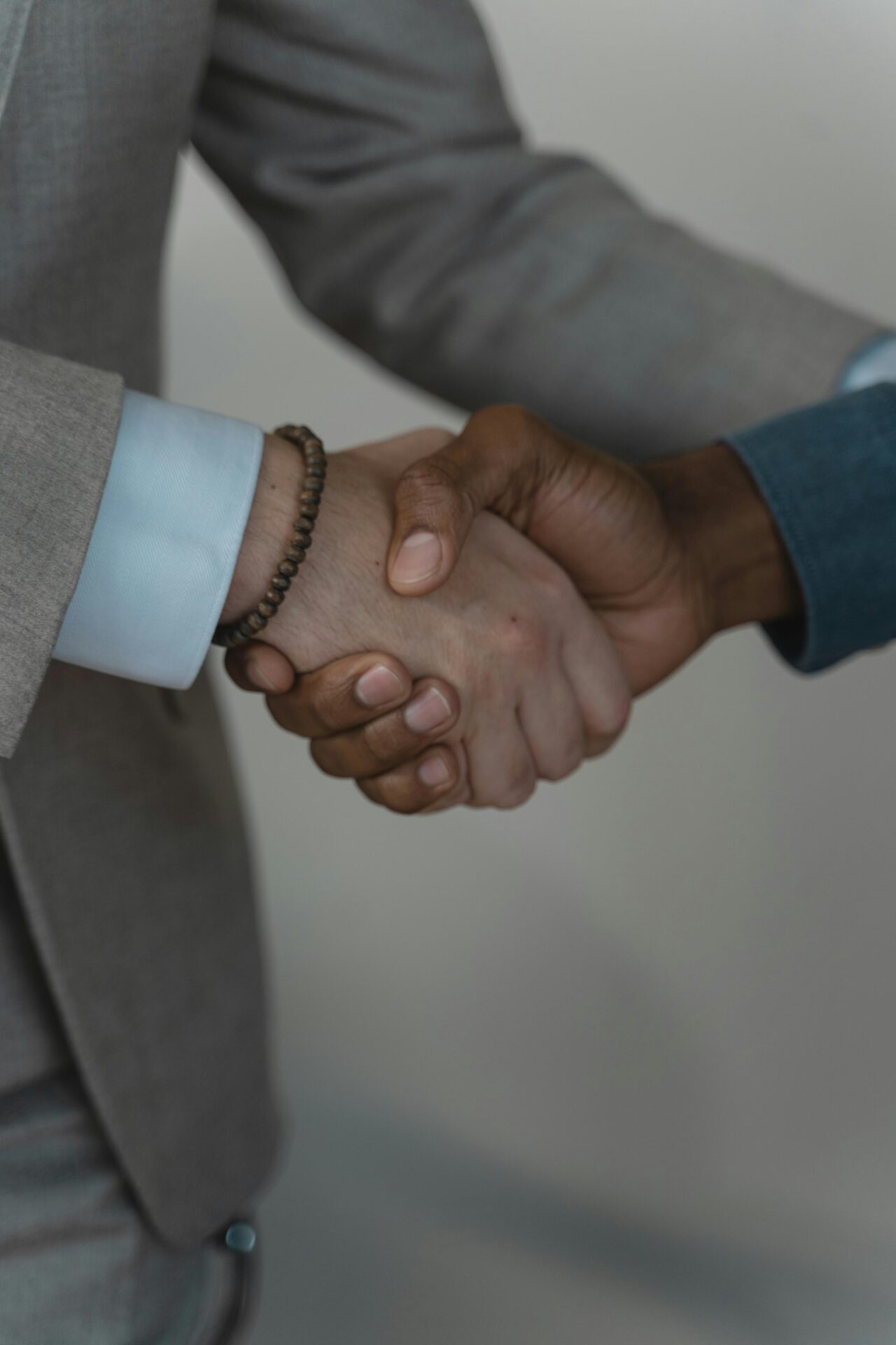 two men shaking hands agreeing b2b paid media strategy - Dig & Dig