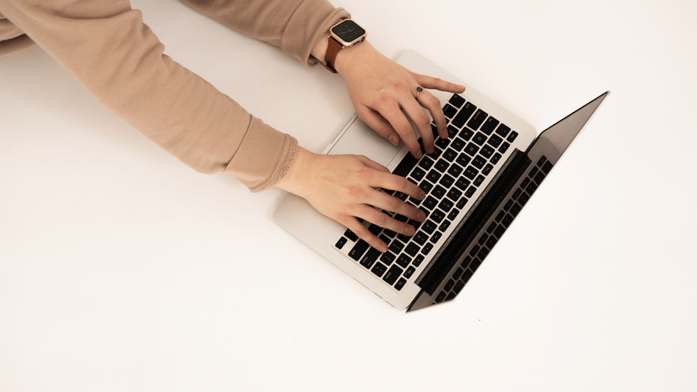 person's arms typing on laptop - Dig & Dig