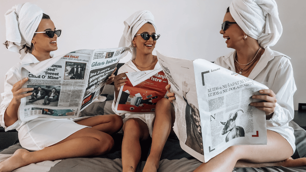 3 Gen Z and Gen Alpha girls with hair towels and reading newspapers - Dig & Dig