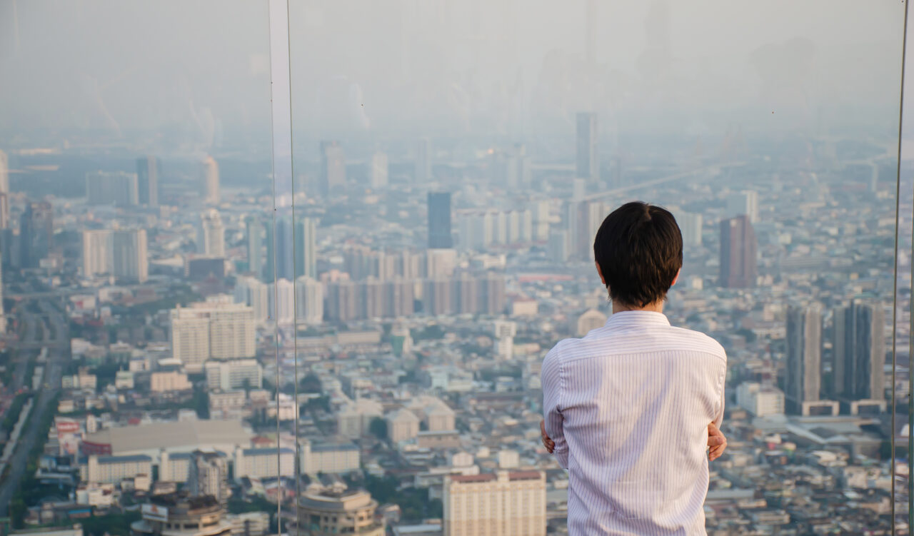 Man looking out window stressed because his SEO ranking has dropped - Dig & Dig