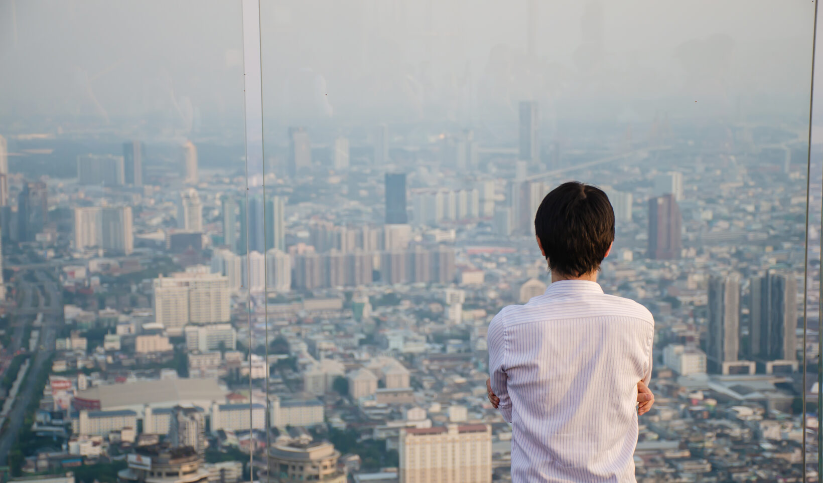 Man looking out window stressed because his SEO ranking has dropped - Dig & Dig