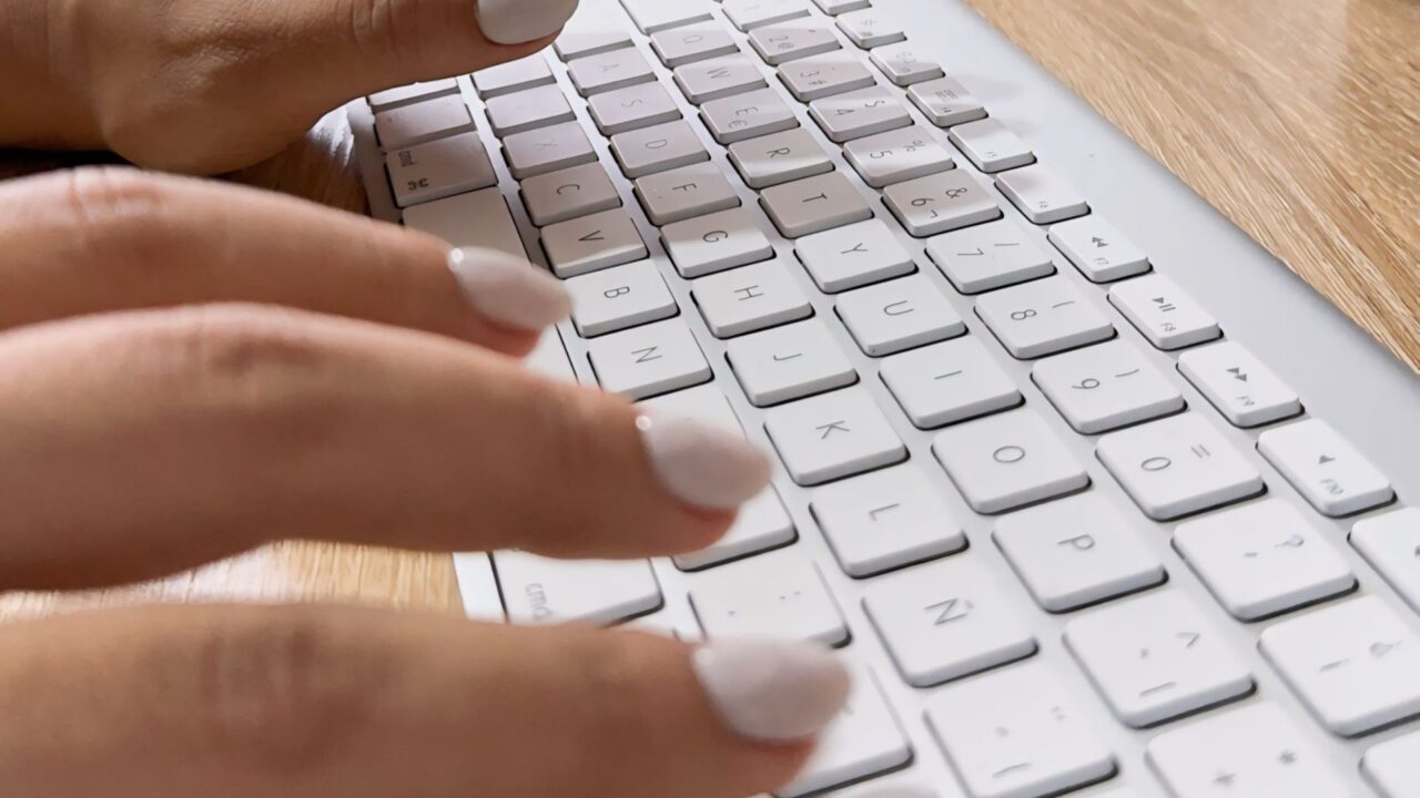 Person typing on keyboard AI PPC strategy - Dig & Dig