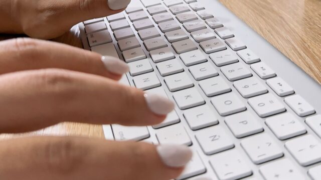 Person typing on keyboard AI PPC strategy - Dig & Dig
